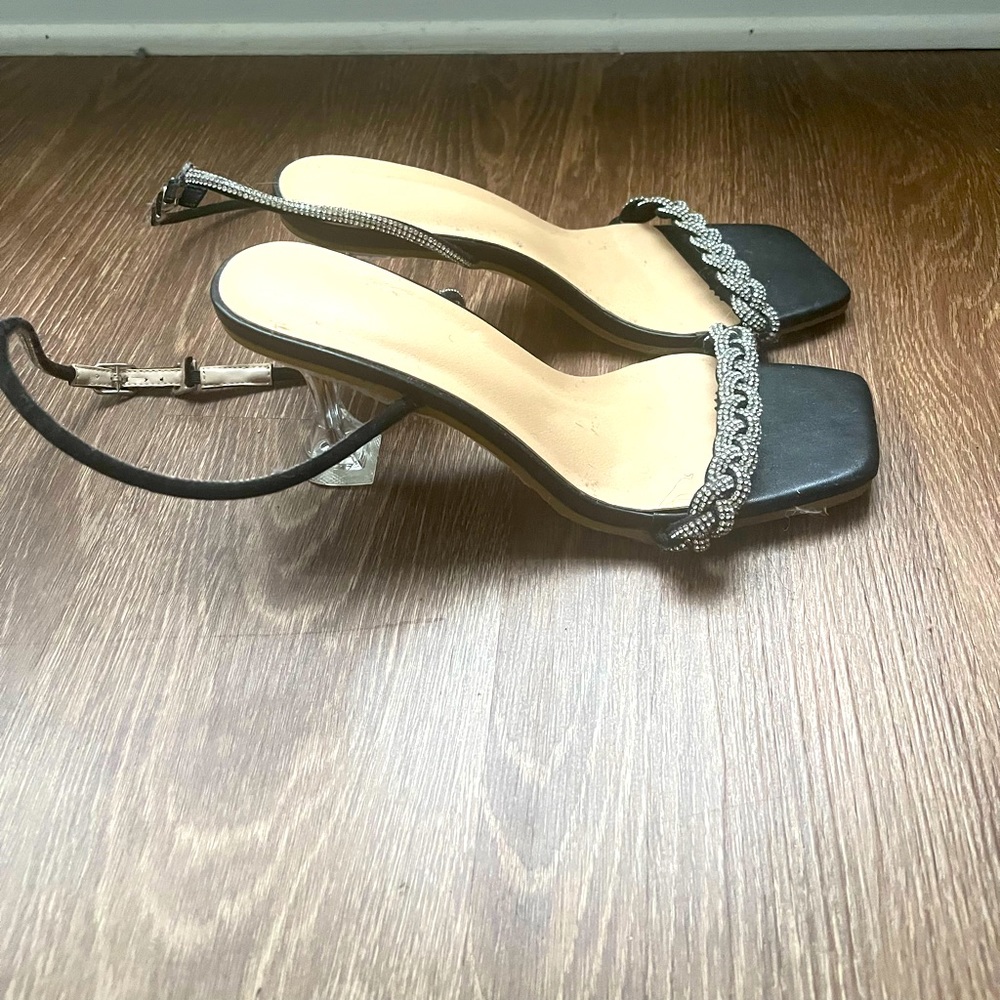 Women’s Black and silver stiletto with clear heels.